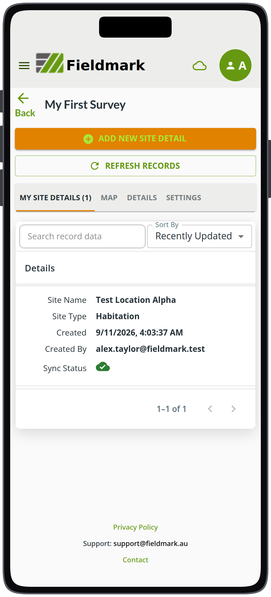 The Fieldmark app on a phone, showing the record list for a notebook called My First Survey. The open tab reads MY SITE DETAILS (1), above a search box and a Sort By dropdown set to Recently Updated. One record is listed under a Details heading: Site Name Test Location Alpha, Site Type Habitation, Created 9/11/2026 at 4:03:37 AM, Created By alex.taylor@fieldmark.test, and Sync Status shown as a green cloud with a tick. A counter below reads 1 to 1 of 1.